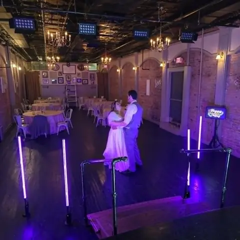 Newlyweds dancing with DJ lighting