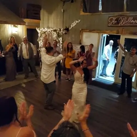 Wedding couple dancing with their guests