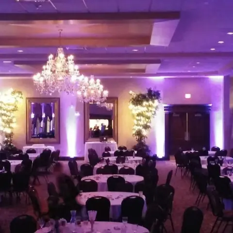 Purple uplighting transforming an event venue
