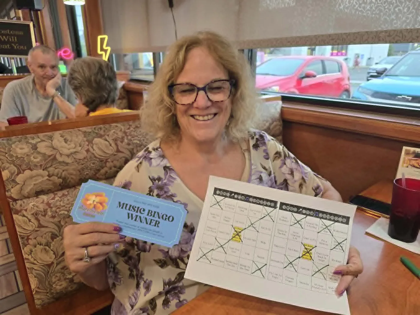 Music Bingo winner holding a winner voucher at American Diner in Monroe, Michigan
