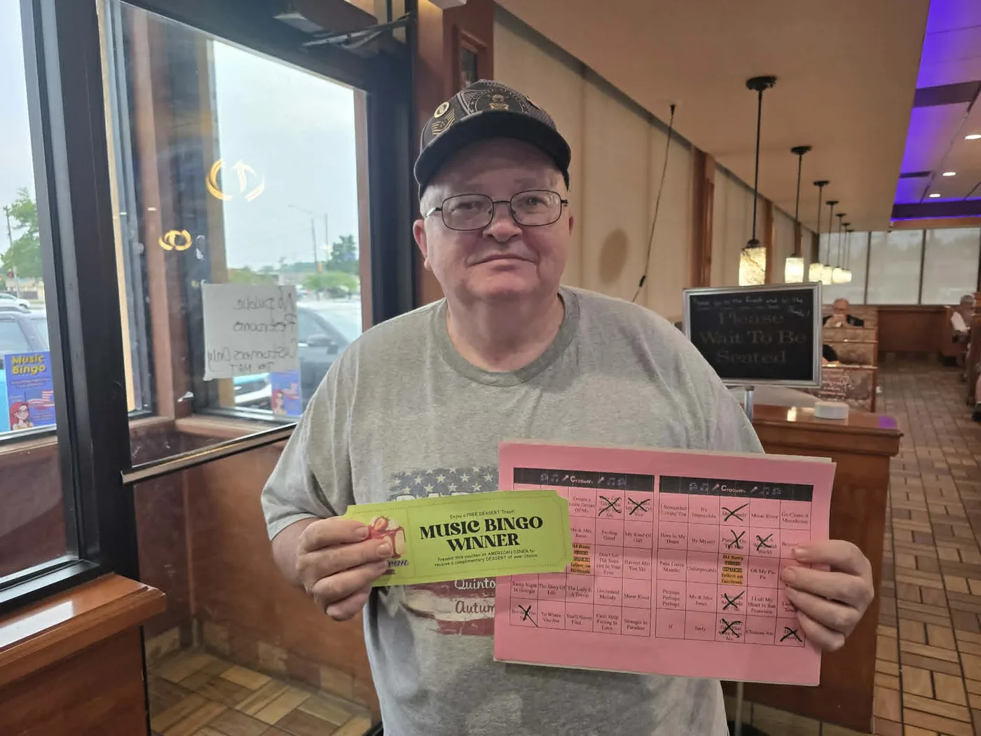 Music Bingo winner with a game card at American Diner in Monroe, Michigan